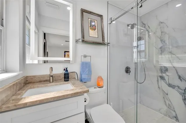 a kitchen with stainless steel appliances granite countertop a stove and a refrigerator