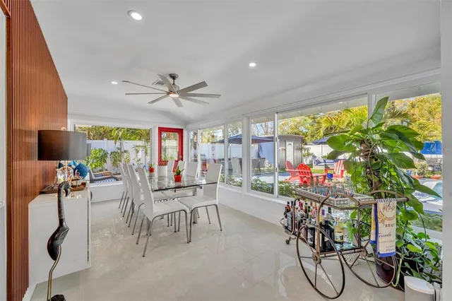 a dining room with furniture and a potted plant