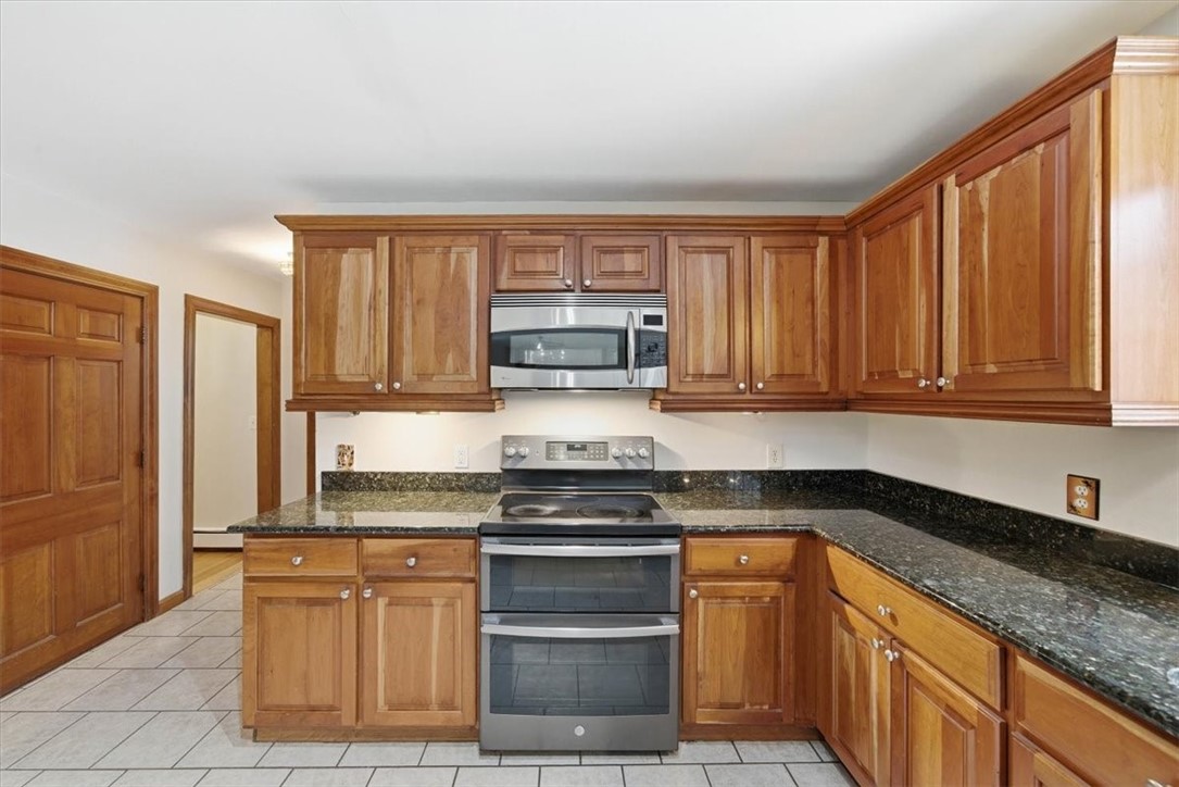 449 Widow Sweets Road Exeter, RI 02822 - Photo 17 of 50 Generous kitchen with solid cherry cabinets, granite counters and SS appliances including a double oven (bake a pie at the same time as a turkey!)