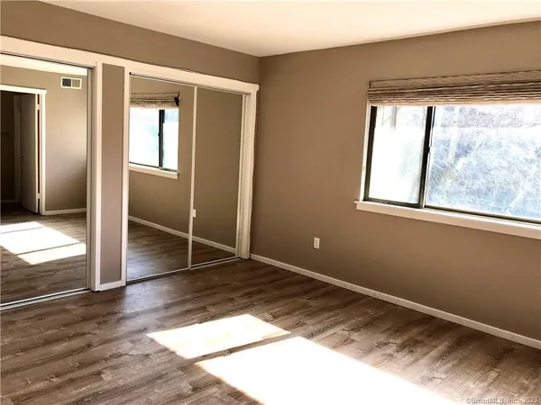 a bathroom with a sink toilet and window