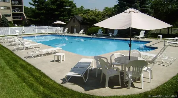 a view of a patio with chairs and umbrellas on a patio