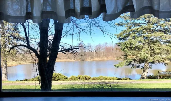 a kitchen with granite countertop white cabinets and a stove top oven