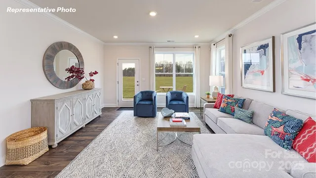 a living room with furniture and kitchen view