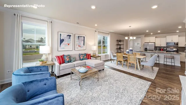 a living room with furniture a window and a clock