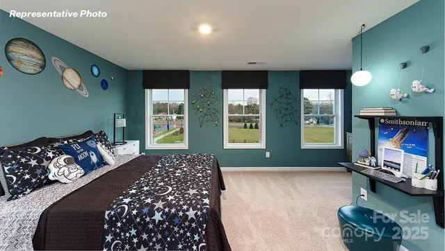 a bedroom with a bed and a dresser next to a window