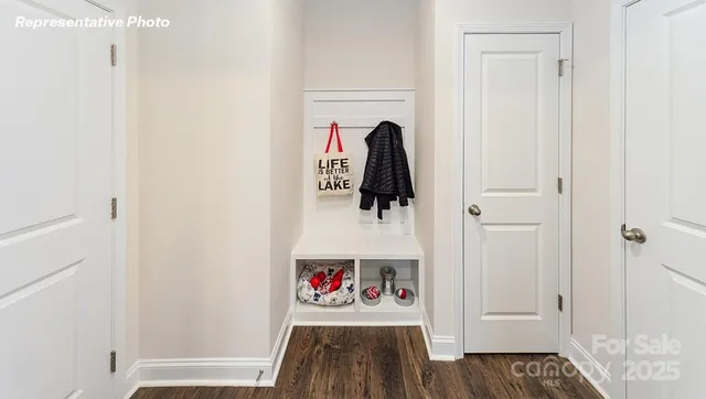 a dining room with wooden floor a chandelier a wooden table and chairs
