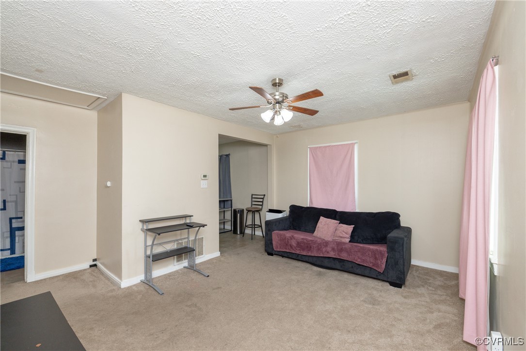 Living room featuring light carpet, and a ceiling