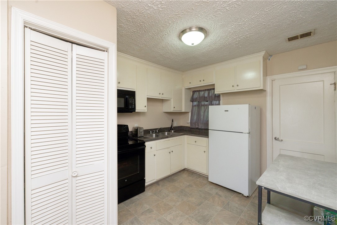 3425 Reynolds Road Richmond, VA 23223 - Photo 8 of 15 Kitchen with black appliances, dark countertops, a