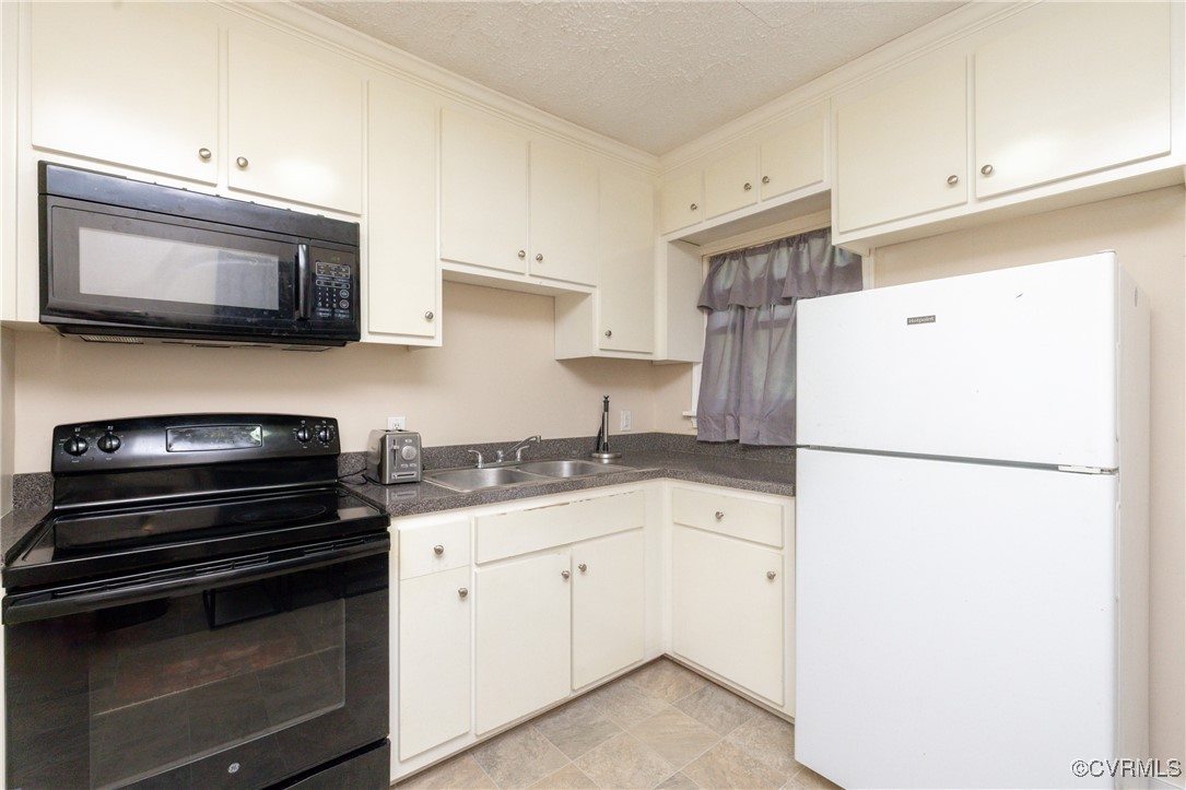3425 Reynolds Road Richmond, VA 23223 - Photo 9 of 15 Kitchen with black appliances, dark countertops, w
