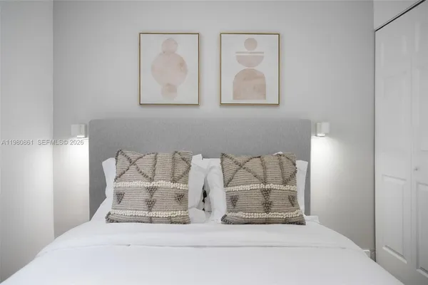a large white bed in a white room