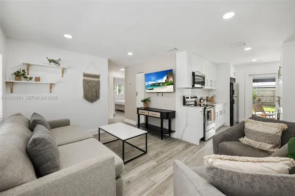 a living room with furniture and kitchen view