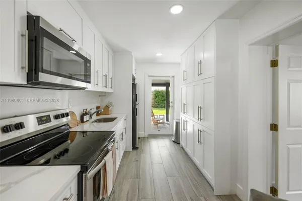 a kitchen with a stove a sink and a microwave