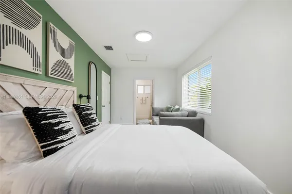 a bedroom with a bed and a window