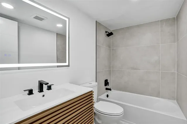 a bathroom with a sink a toilet and a bathtub