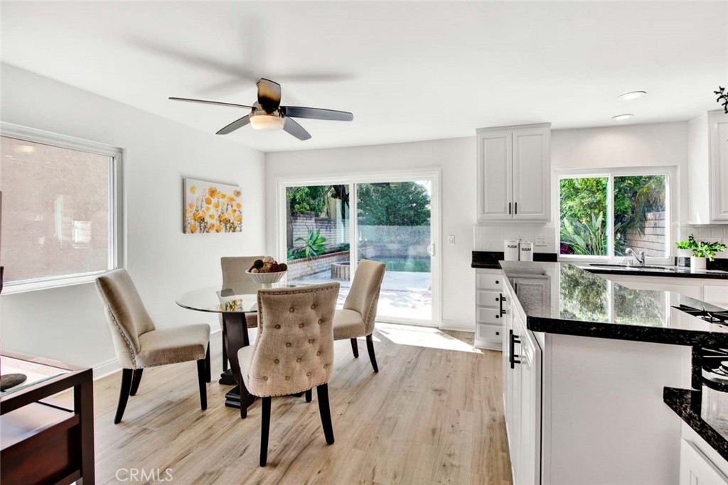 60 Willow Tree Lane Irvine, CA 92612 - Photo 17 of 74 a dining room with furniture a chandelier and wooden floor