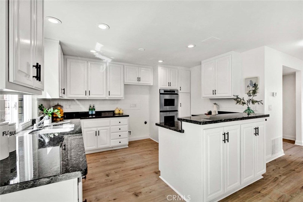 60 Willow Tree Lane Irvine, CA 92612 - Photo 22 of 74 a kitchen with granite countertop a sink stove and cabinets