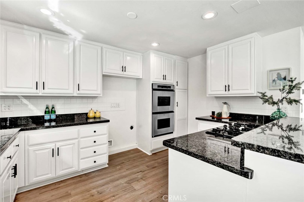 60 Willow Tree Lane Irvine, CA 92612 - Photo 23 of 74 a kitchen with granite countertop a sink and cabinets