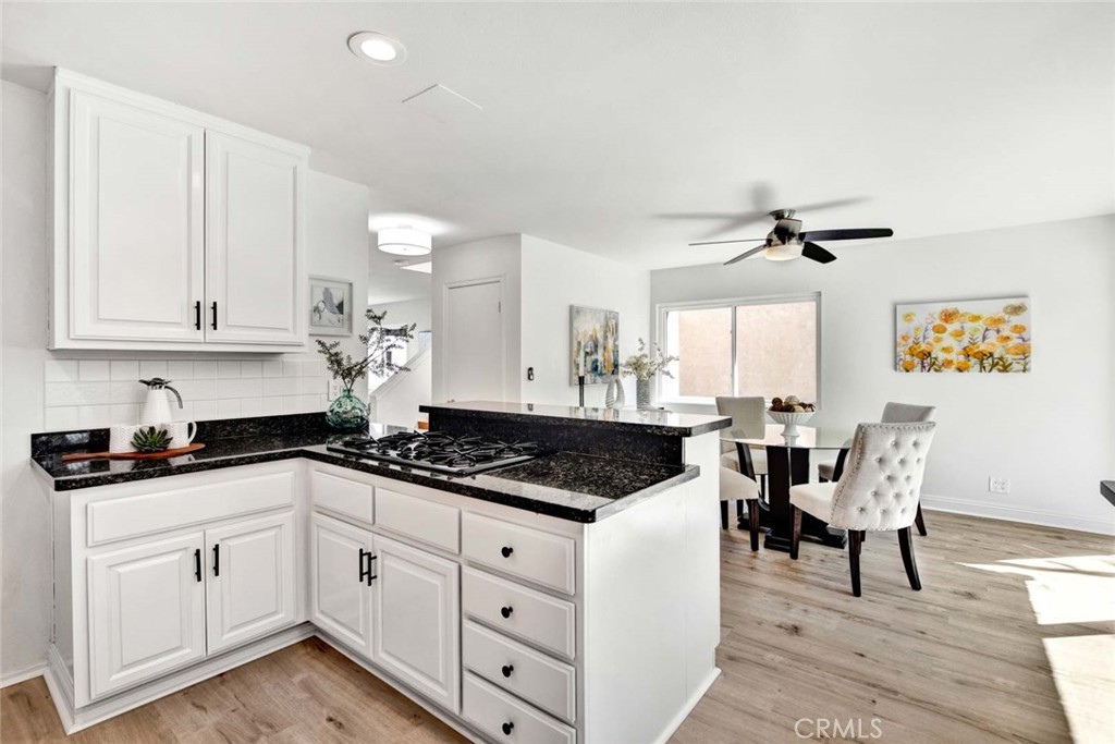 60 Willow Tree Lane Irvine, CA 92612 - Photo 24 of 74 a kitchen with granite countertop white cabinets and white appliances