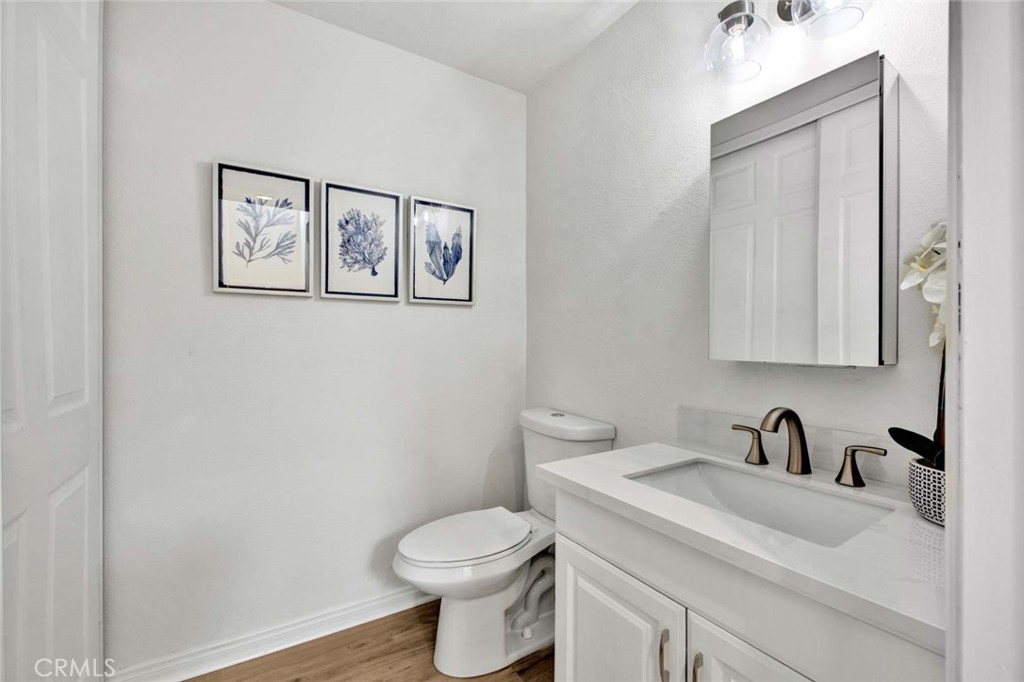 60 Willow Tree Lane Irvine, CA 92612 - Photo 28 of 74 a white toilet sitting next to a bathroom sink