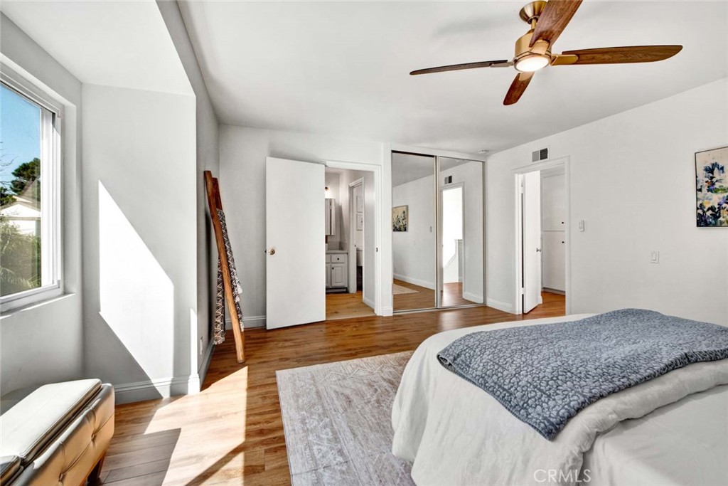 60 Willow Tree Lane Irvine, CA 92612 - Photo 34 of 74 a bedroom with a large bed and a chandelier