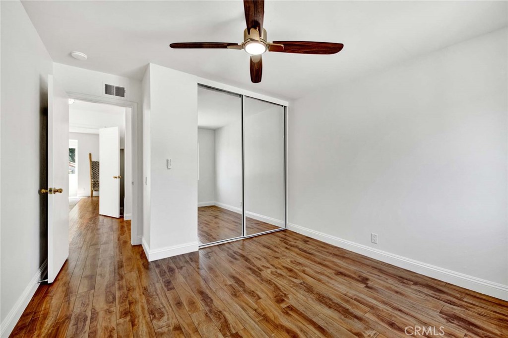 60 Willow Tree Lane Irvine, CA 92612 - Photo 44 of 74 a view of a hallway with wooden floor