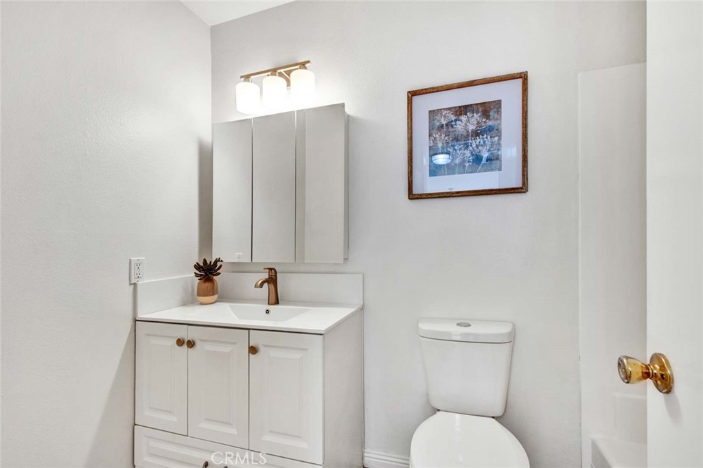 60 Willow Tree Lane Irvine, CA 92612 - Photo 45 of 74 a bathroom with a toilet sink and mirror