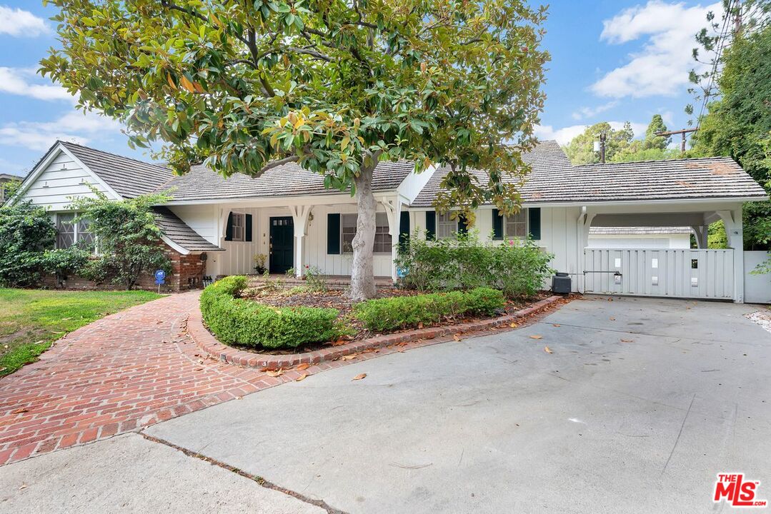 791 North Bundy Drive Los Angeles, CA 90049 - Photo 2 of 33 a front view of a house with a garden