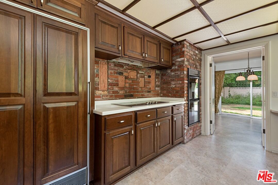 791 North Bundy Drive Los Angeles, CA 90049 - Photo 13 of 33 a kitchen with stainless steel appliances granite countertop a refrigerator and a sink