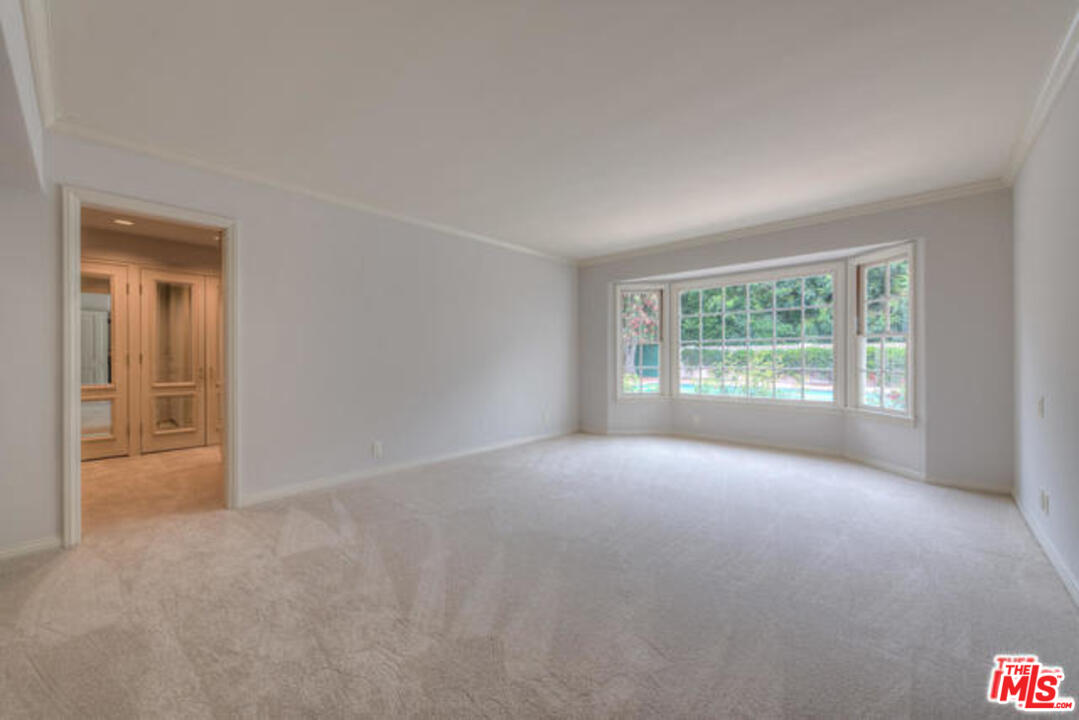 791 North Bundy Drive Los Angeles, CA 90049 - Photo 21 of 33 a view of a big room with windows and chandelier fan