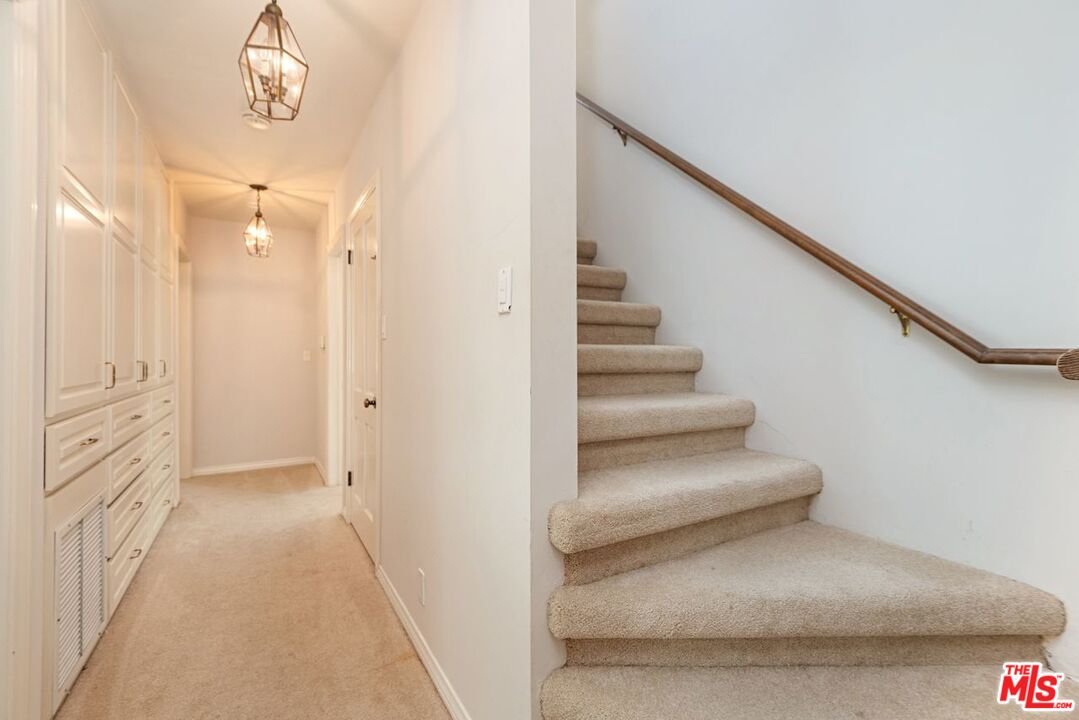 791 North Bundy Drive Los Angeles, CA 90049 - Photo 25 of 33 a view of a hallway with wooden floor and staircase