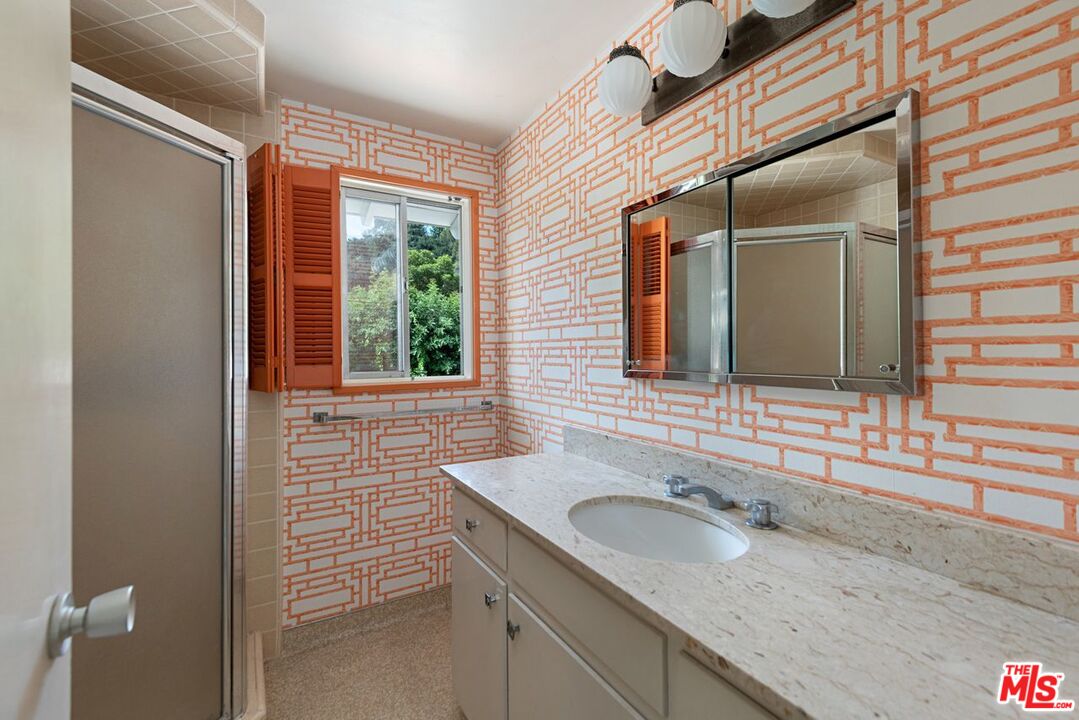 791 North Bundy Drive Los Angeles, CA 90049 - Photo 28 of 33 a bathroom with a granite countertop sink and a window