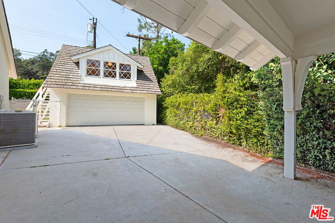 791 North Bundy Drive Los Angeles, CA 90049 - Photo 33 of 33 a front view of a house with a yard and garage