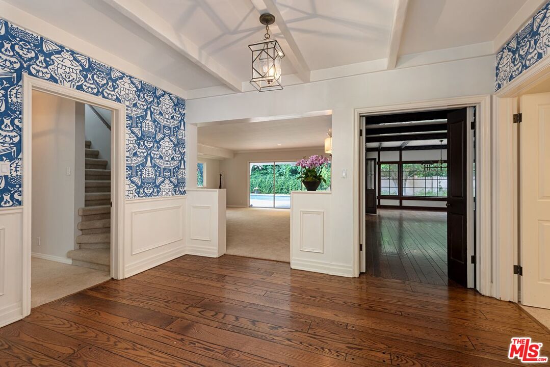 791 North Bundy Drive Los Angeles, CA 90049 - Photo 5 of 33 a view of a hallway view with fireplace and wooden floor