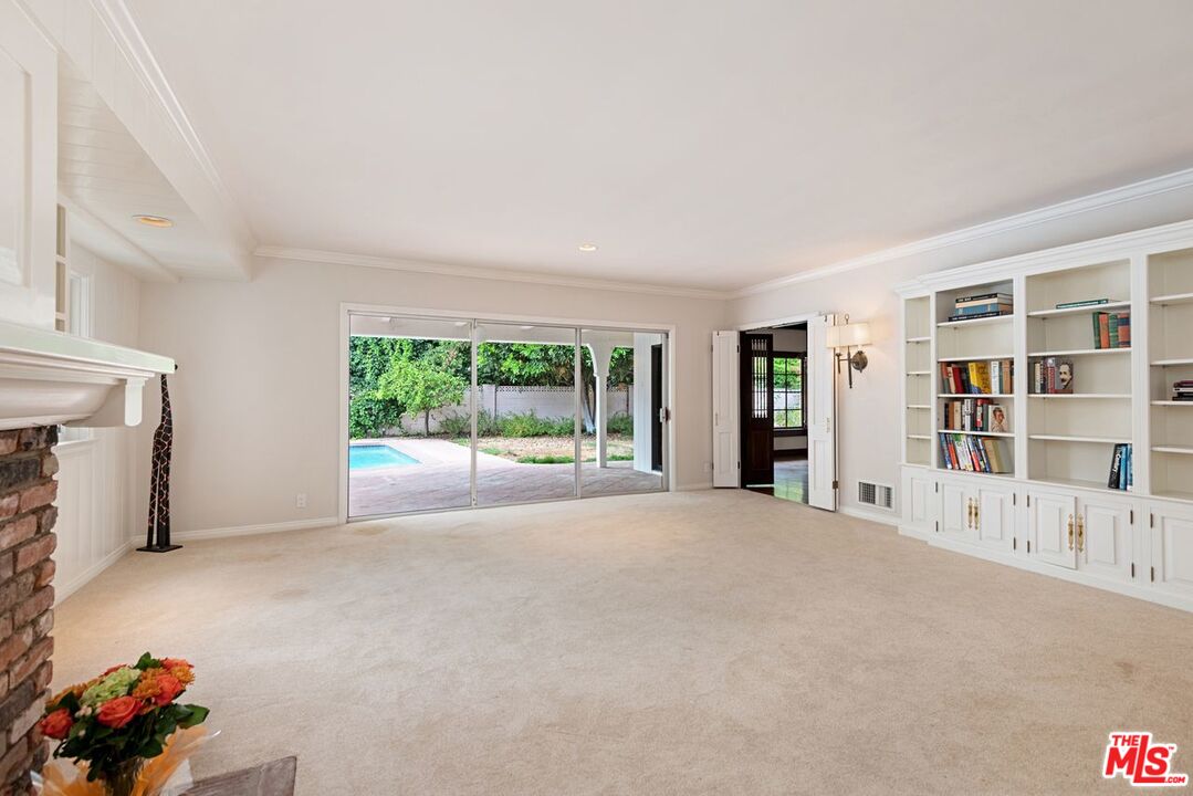 791 North Bundy Drive Los Angeles, CA 90049 - Photo 7 of 33 a view of an empty room with a window and fire place