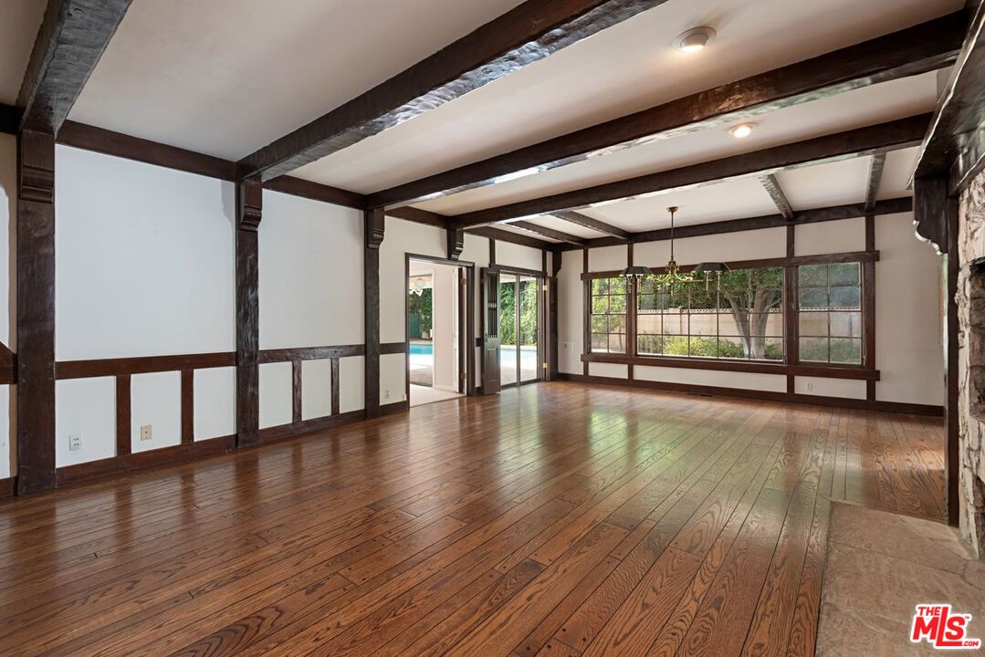 791 North Bundy Drive Los Angeles, CA 90049 - Photo 8 of 33 a view of an empty room with wooden floor and floor to ceiling window