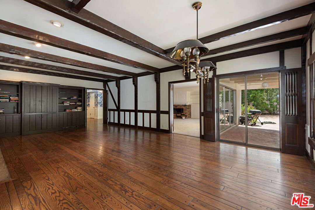 791 North Bundy Drive Los Angeles, CA 90049 - Photo 9 of 33 a view of a hallway with wooden floor and windows