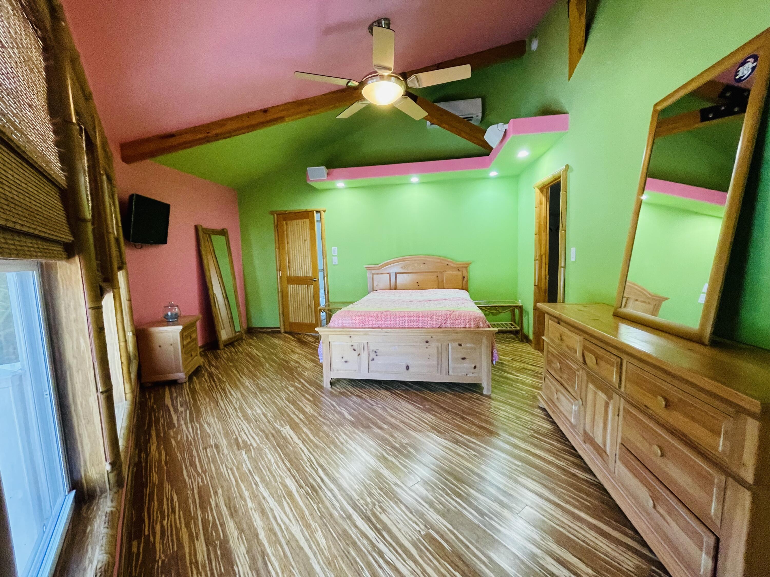 30451 Hibiscus Lane Big Pine Key, FL 33043 - Photo 22 of 32 a spacious bedroom with a bed and a flat tv screen