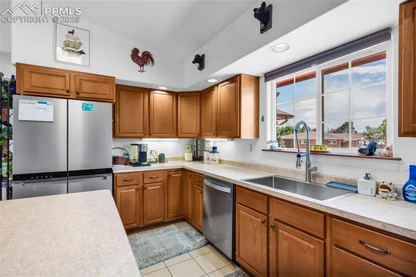 a kitchen with a sink window and cabinets