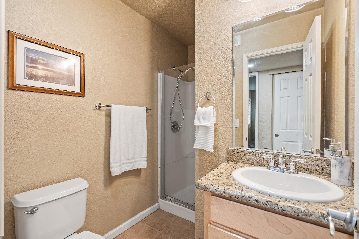 6235 Riverside Boulevard, Unit 2 Sacramento, CA 95831 - Photo 13 of 17 a bathroom with a granite countertop sink toilet and shower