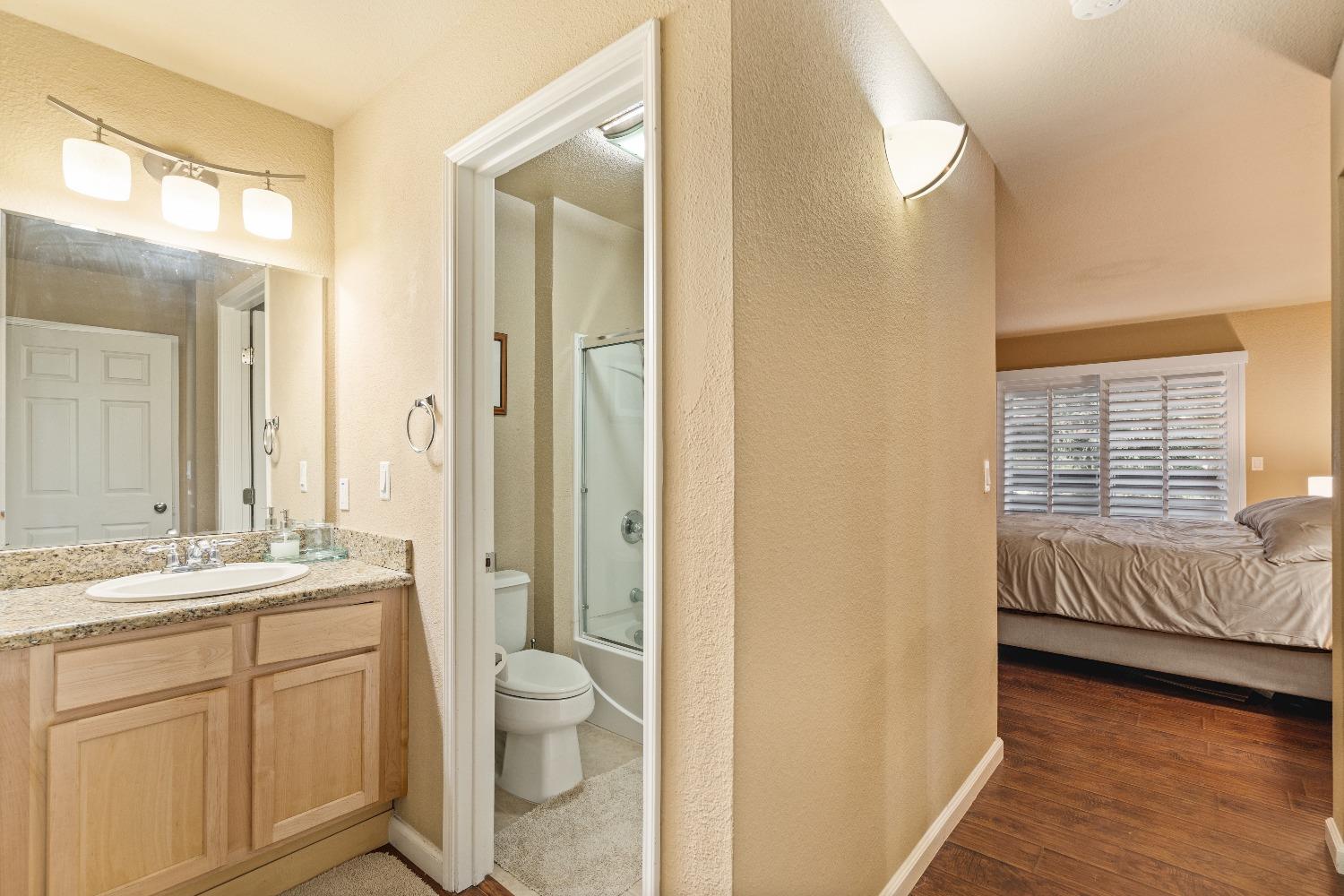 6235 Riverside Boulevard, Unit 2 Sacramento, CA 95831 - Photo 16 of 17 a spacious bathroom with a granite countertop sink toilet and shower