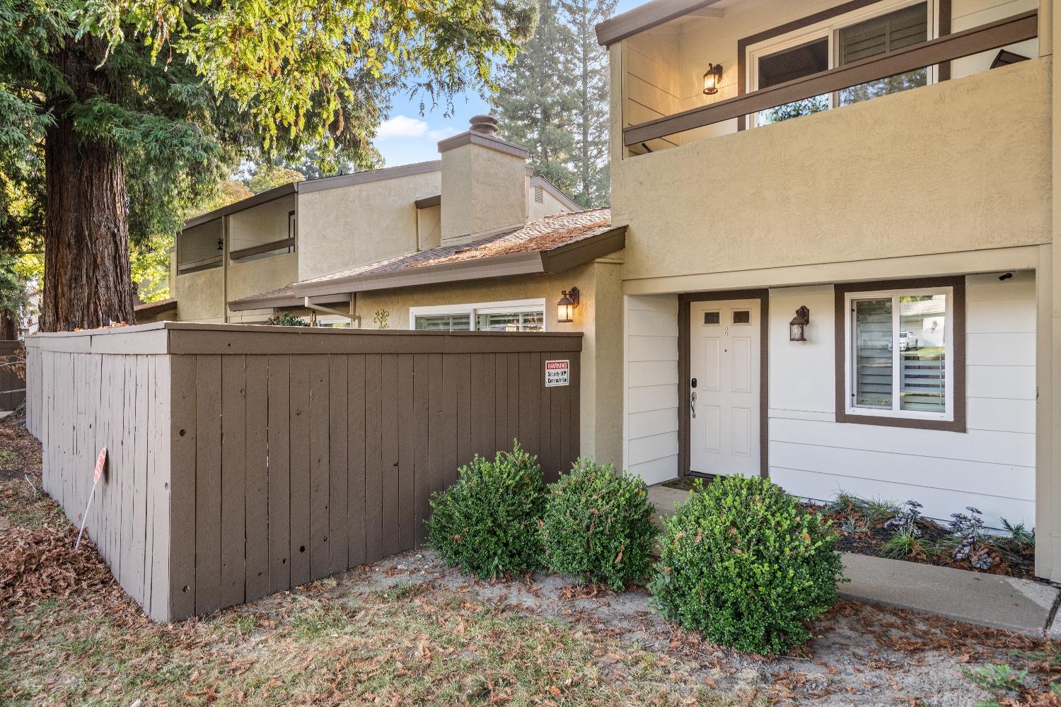 6235 Riverside Boulevard, Unit 2 Sacramento, CA 95831 - Photo 2 of 17 a view of a house with wooden fence next to a road