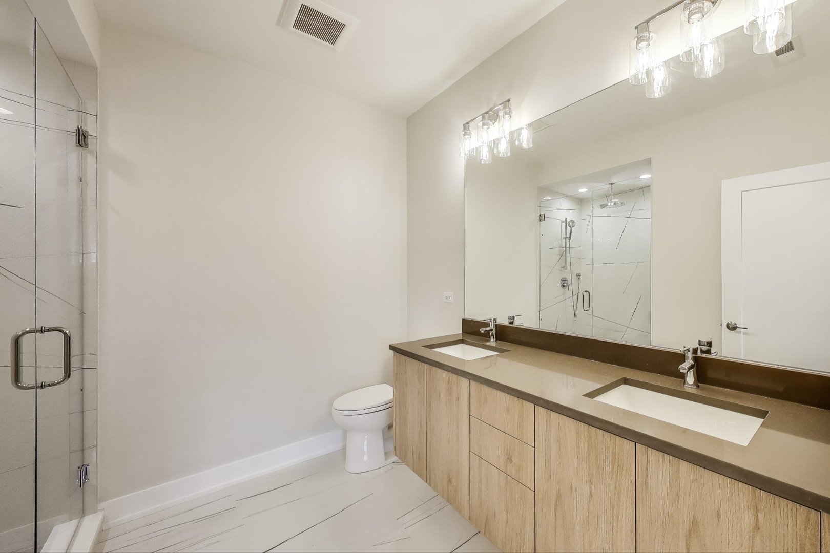 3339 North Ridgeway Avenue, Unit 2N Chicago, IL 60618 - Photo 12 of 29 a bathroom with a sink a toilet and a mirror