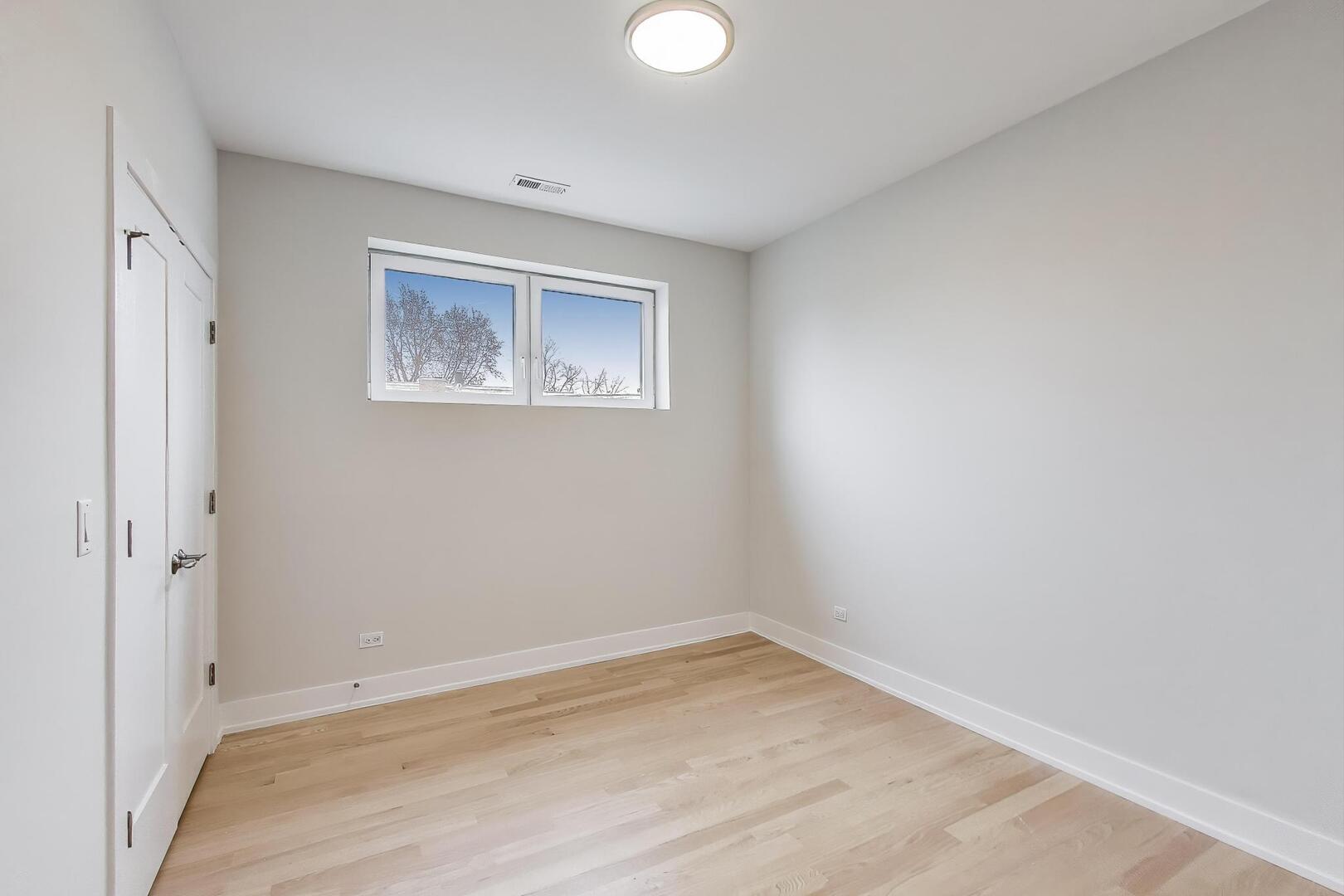 3339 North Ridgeway Avenue, Unit 2N Chicago, IL 60618 - Photo 15 of 29 a view of empty room with wooden floor