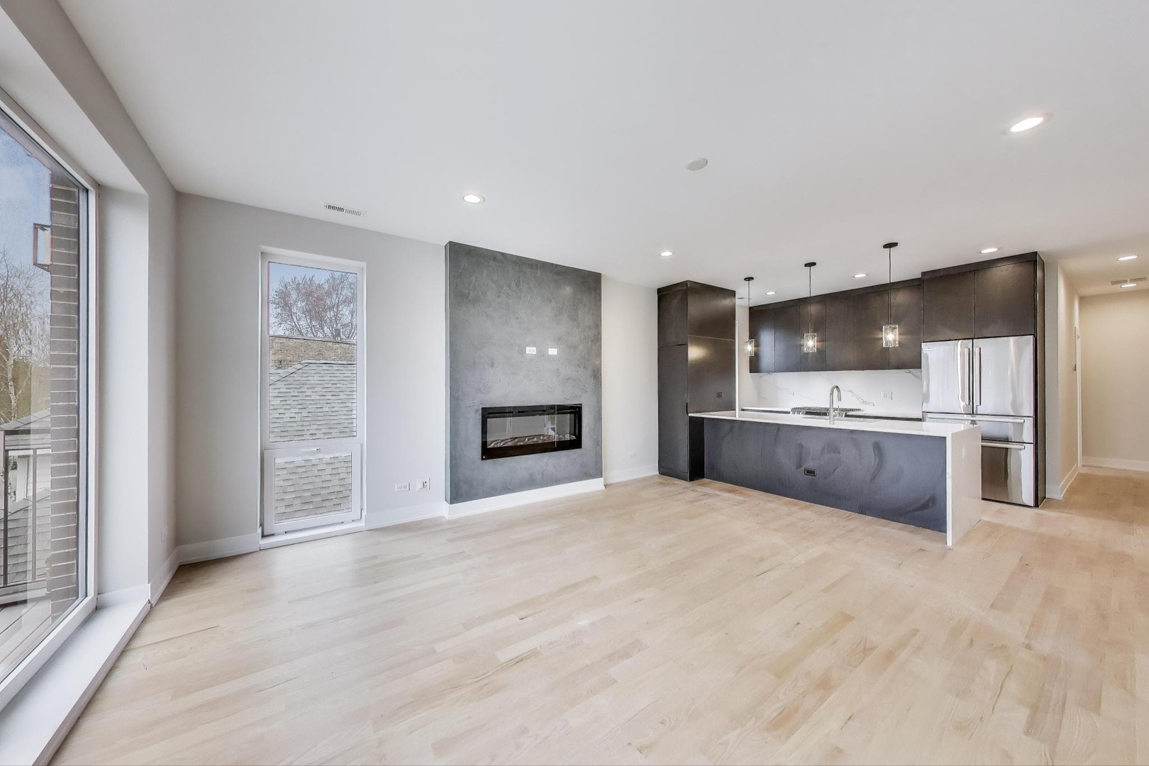 3339 North Ridgeway Avenue, Unit 2N Chicago, IL 60618 - Photo 5 of 29 a large white kitchen with kitchen island a sink stainless steel appliances and cabinets