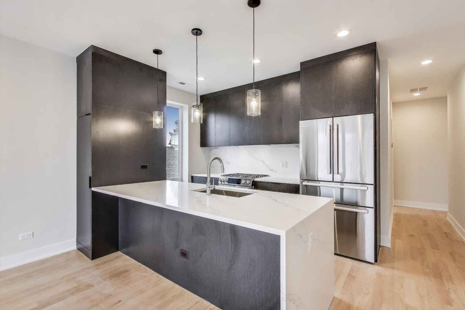 3339 North Ridgeway Avenue, Unit 2N Chicago, IL 60618 - Photo 6 of 29 a kitchen with kitchen island a sink stainless steel appliances and cabinets