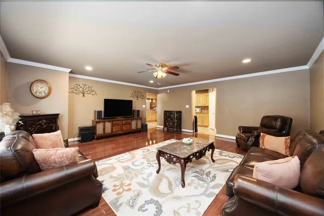 a living room with furniture and wooden floor