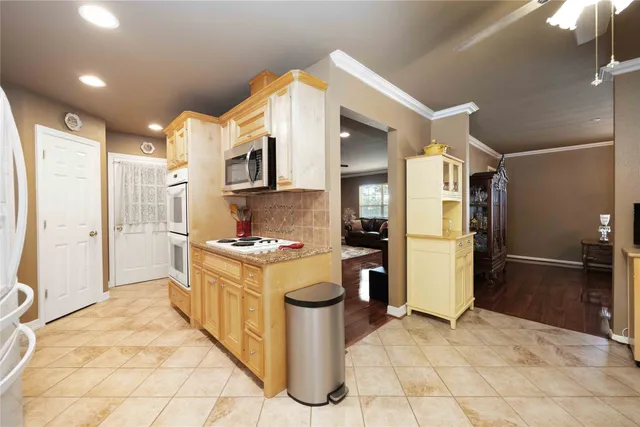 a kitchen with stainless steel appliances granite countertop a stove a refrigerator and a oven