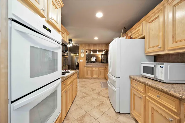 a kitchen with a refrigerator sink and stove