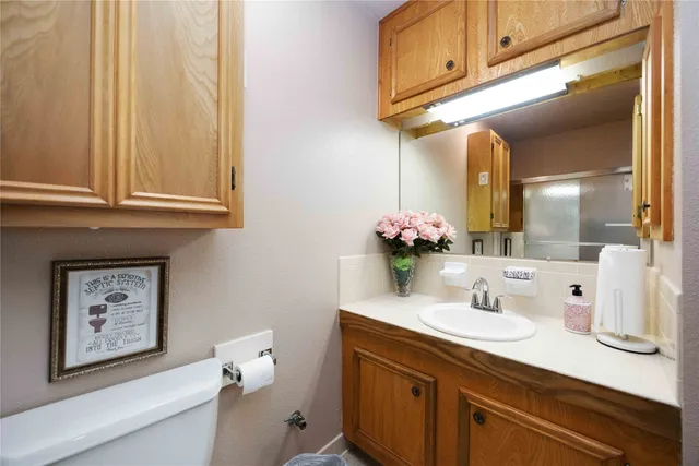 a bathroom with a sink vanity and a mirror