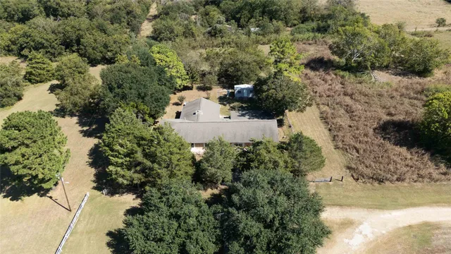 an aerial view of a house with a yard
